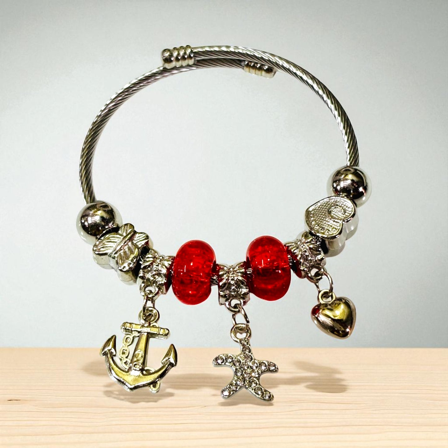 Silver Tone Charm Bracelet with Red Beads.